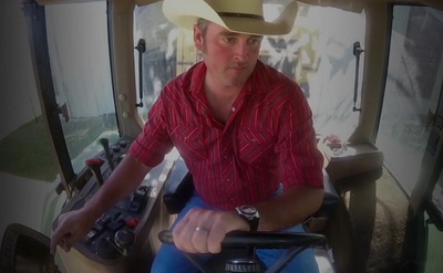 Farmer Bryan Stevens in the cab of one of his farm implement