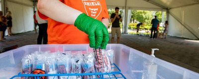 saliva testing on Urbana campus - glove with test tube