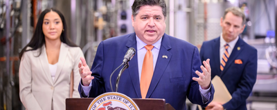 Governor Pritzker at a lectern