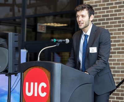 UIC student consultant Olsi Shehu speaks at a UIC podium