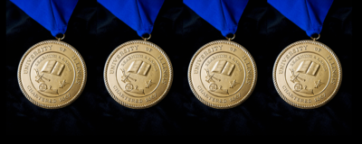 gold medallions of U of I seal on blue ribbons